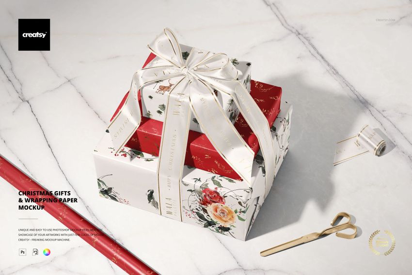 Christmas gifts mockup featuring stacked boxes, gold scissors, ribbon roll, and wrapping paper on a light marble background.
