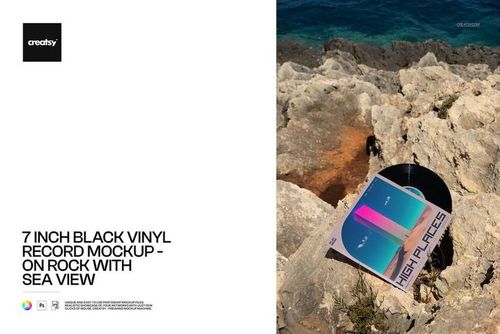 Top view of a 7 inch black vinyl record mockup resting on textured rocks with ocean waves in the background.