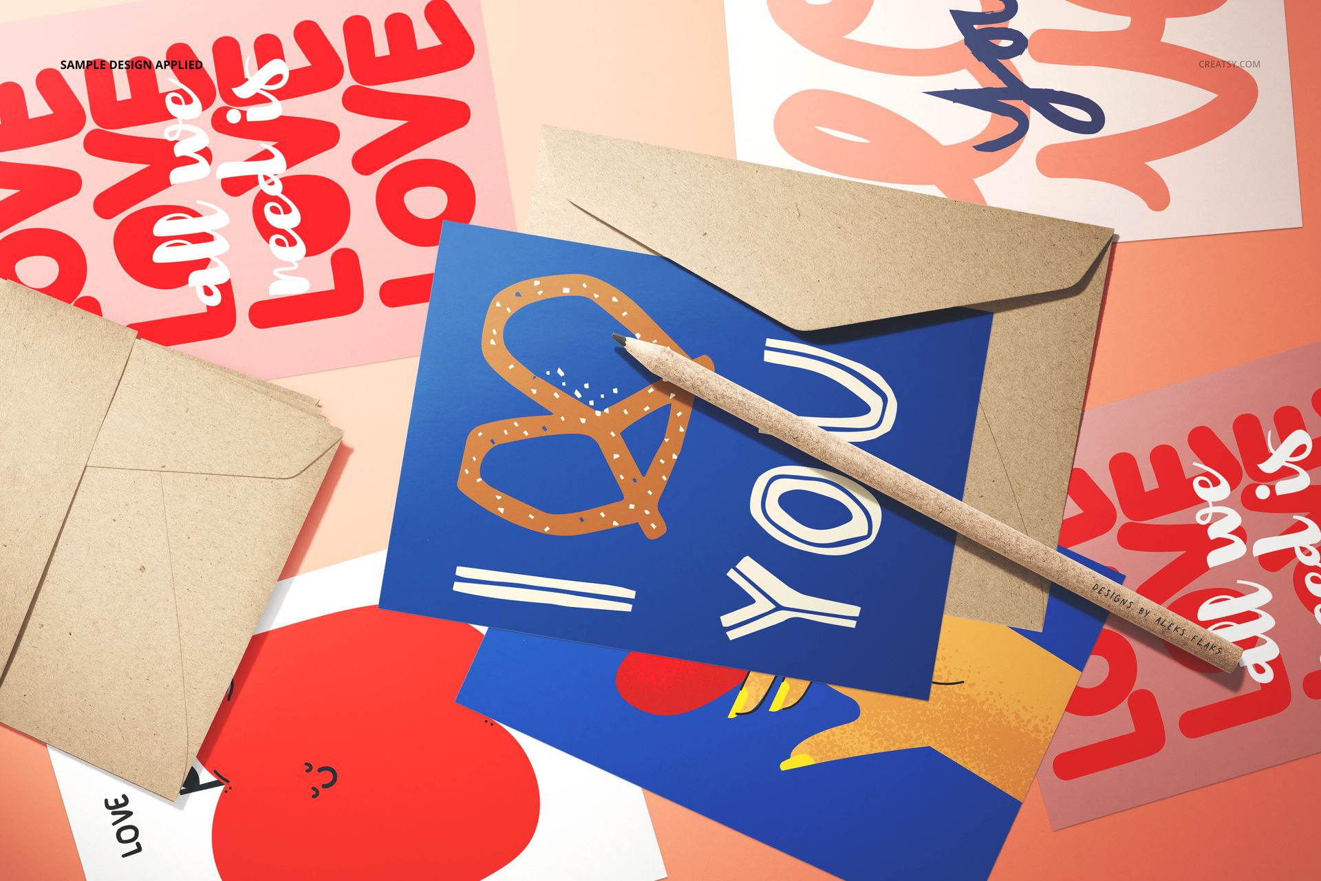 Valentines cards mockup featuring various illustrated cards, envelopes, and a pencil on a soft pink surface.