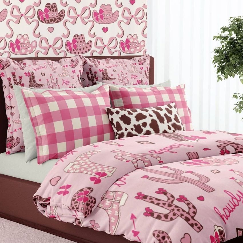 Bedding mockup featuring a pink western-themed duvet cover and pillows with cowboy hats, cacti, and checkered patterns in a bedroom scene.