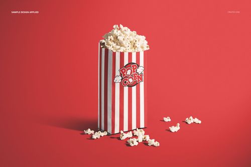 Popcorn paper bag mockup featuring a striped design in red and white, filled with popcorn, on a red surface.