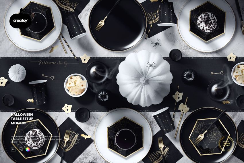Halloween table arrangement in a PSD mockup featuring black and gold dishes, white pumpkin, and festive props.
