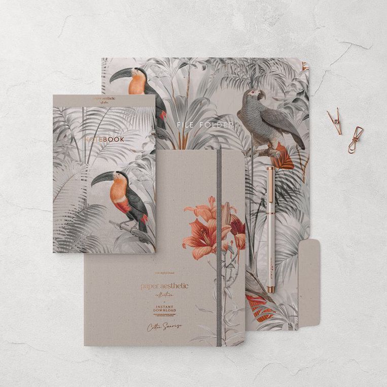 Stationery set mockup featuring a notebook, file folder, and cards with tropical bird and foliage patterns in muted tones.