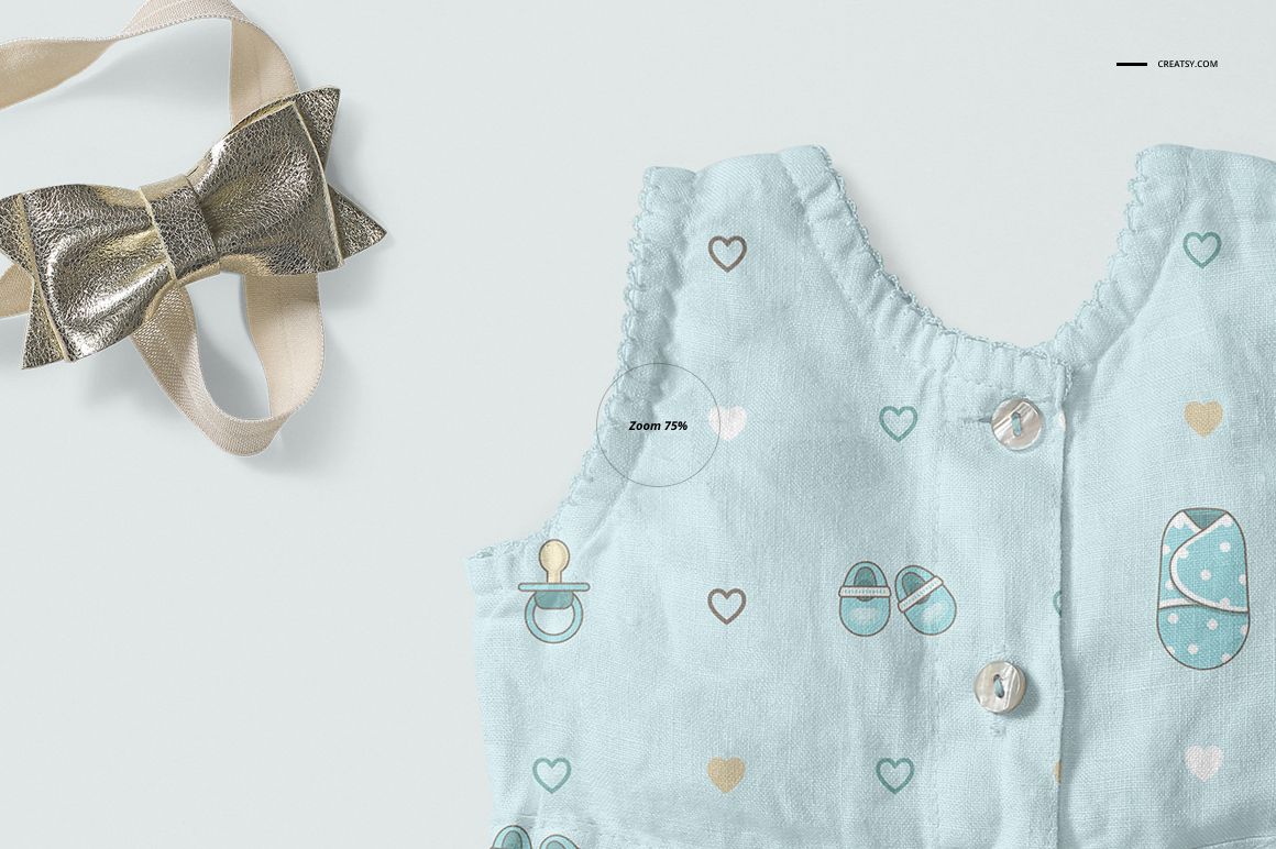 PSD mockup featuring a baby dress decorated with hearts and pacifiers, next to a gold textured bow on a light background.