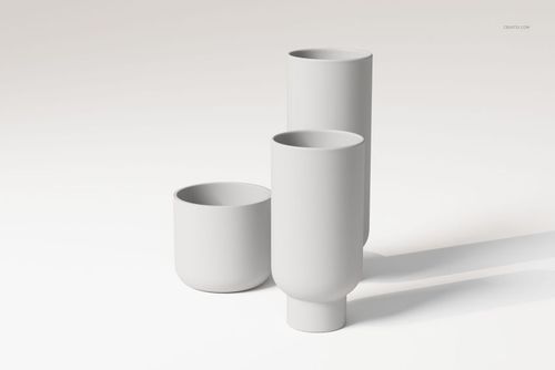 Three minimalist stoneware vases in matte white, featuring cylindrical and rounded shapes, displayed on a plain surface.