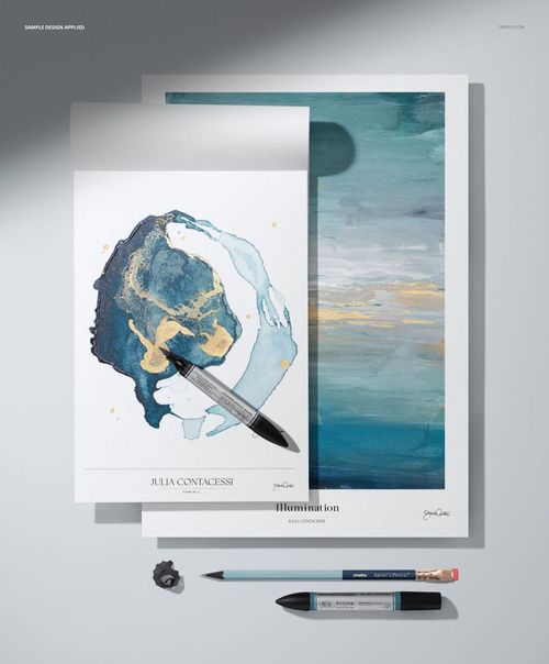 PSD mockup showing two art paper pads, abstract paintings, and drawing tools arranged from a top perspective.