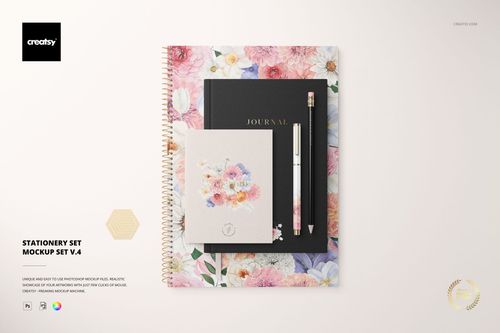 Top view of a stationery set mockup featuring a floral spiral notebook, black journal, pen, and floral card on a light background.