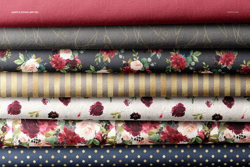 Fabric stack mockup displaying multiple folded textiles in red, gray, and cream tones with assorted patterns.