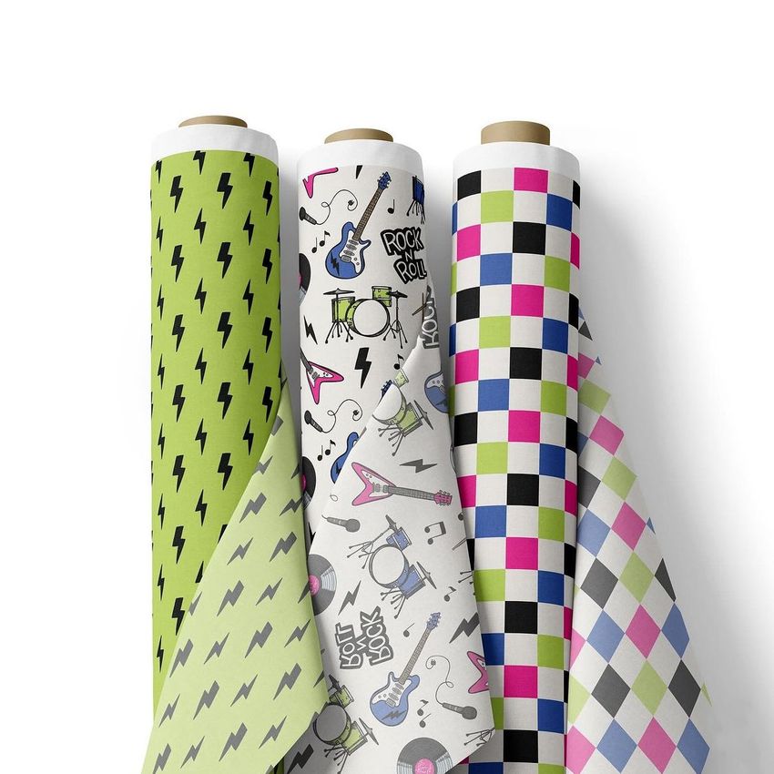 Fabric rolls mockup showing three upright rolls with different patterns, including lightning bolts, musical instruments, and colorful checks.