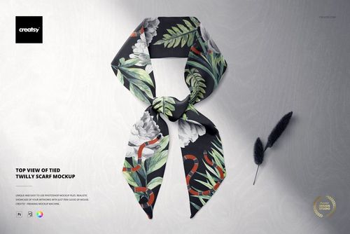 Tied twilly scarf mockup shown from above, featuring green leaves and white flowers on a black fabric.