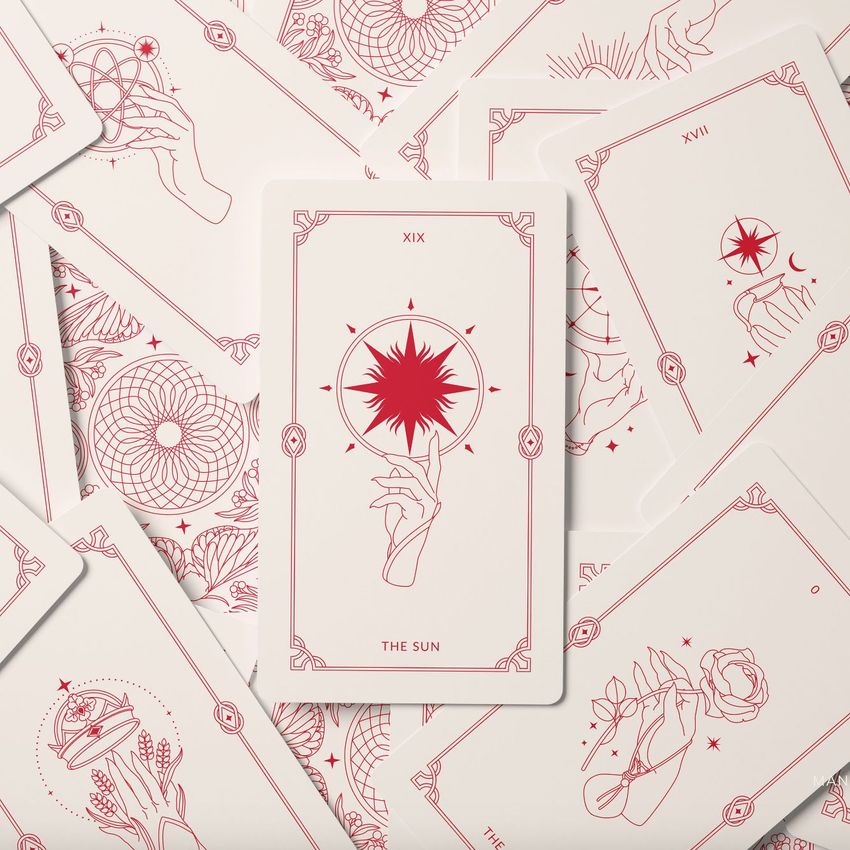 Tarot cards mockup featuring a central card with a hand and star illustration, surrounded by other cards with red line art designs.
