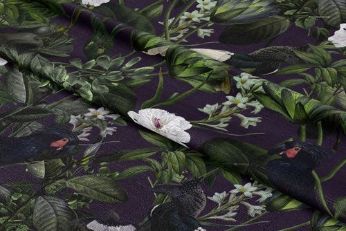 Close-up of a tablecloth fabric mockup displaying a vivid botanical and bird design on a textured surface.