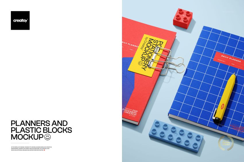 Stationery mockup featuring planners, colorful plastic blocks, a pen, and binder clips displayed from above on a blue tabletop.