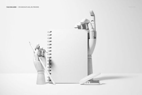 Spiral planner mockup displayed upright between articulated wooden hands, with writing tools beside it on a white background.