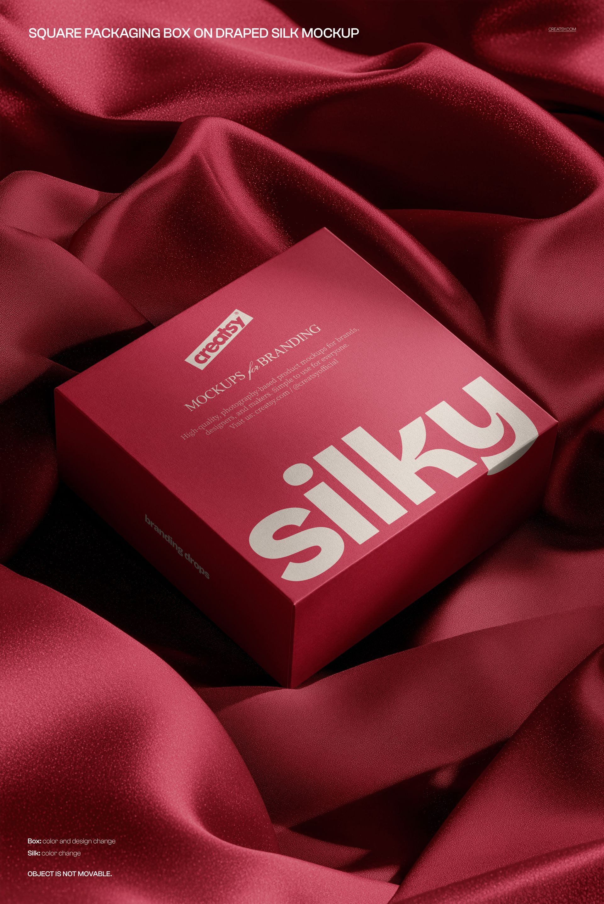 Square red packaging box with bold white lettering placed on a draped silky red fabric, front view.
