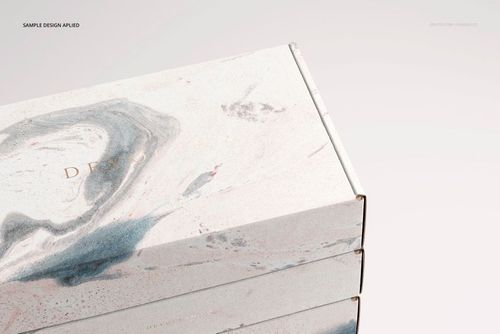 PSD mockup featuring stacked packaging boxes with light gray and blush abstract swirls, viewed from the top right corner.