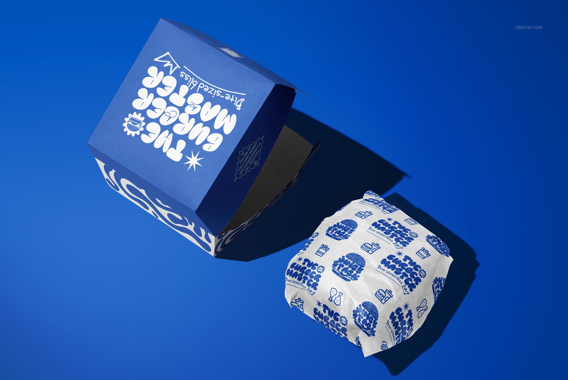 Blue burger packaging mockup with white graphic text, showing both an open box and wrapped burger on blue surface.