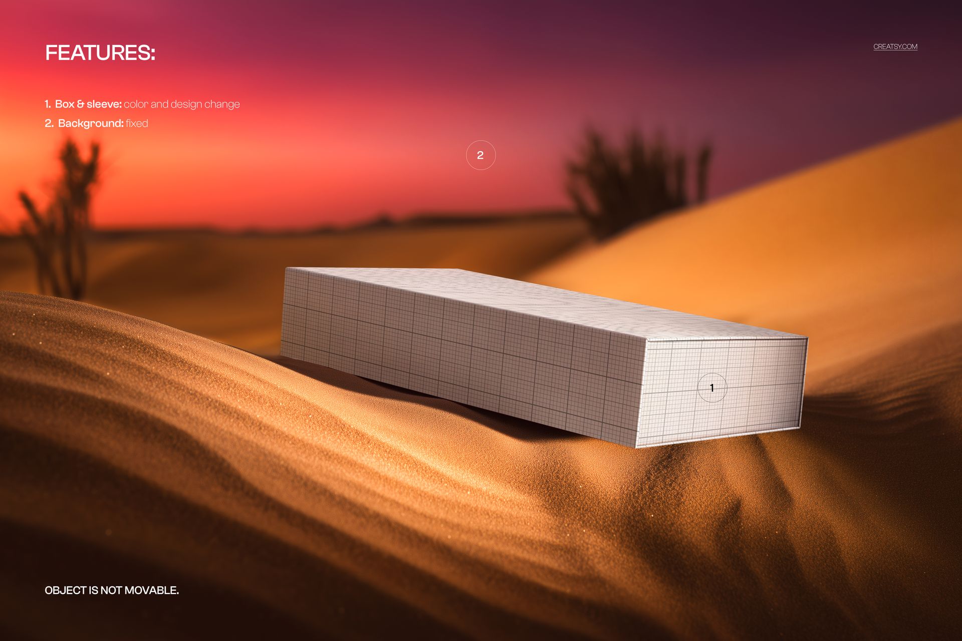 Rectangular sleeve slide box mockup with a grid pattern resting on golden sand dunes at sunset, front angle view.