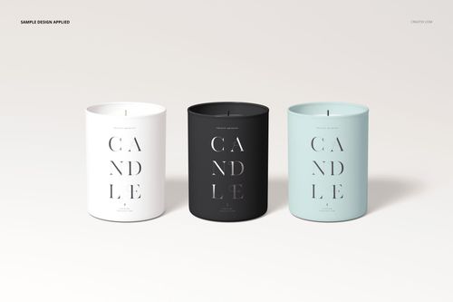 PSD mockup displaying a trio of cylindrical candles with cotton wicks, each in a different solid color container.