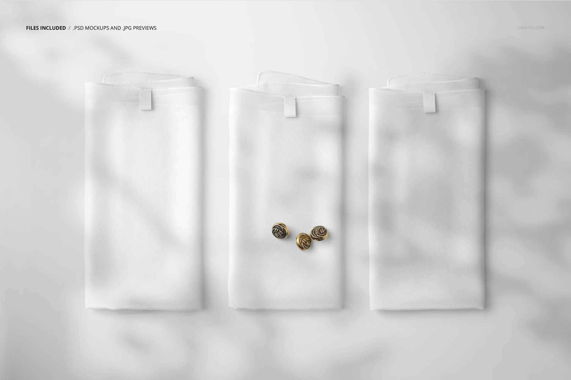 PSD mockup showing three folded silk scarves in a row on a light background, with gentle shadow effects and three gold buttons.