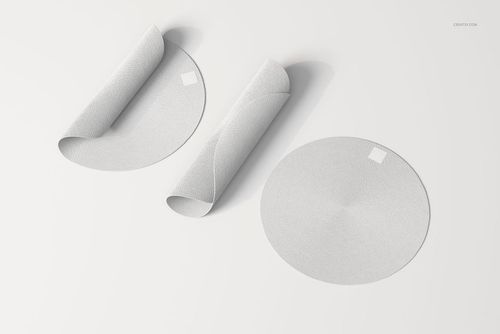 Round braided rugs displayed on a white surface, with one rug fully flat and two rugs partially rolled to show texture.