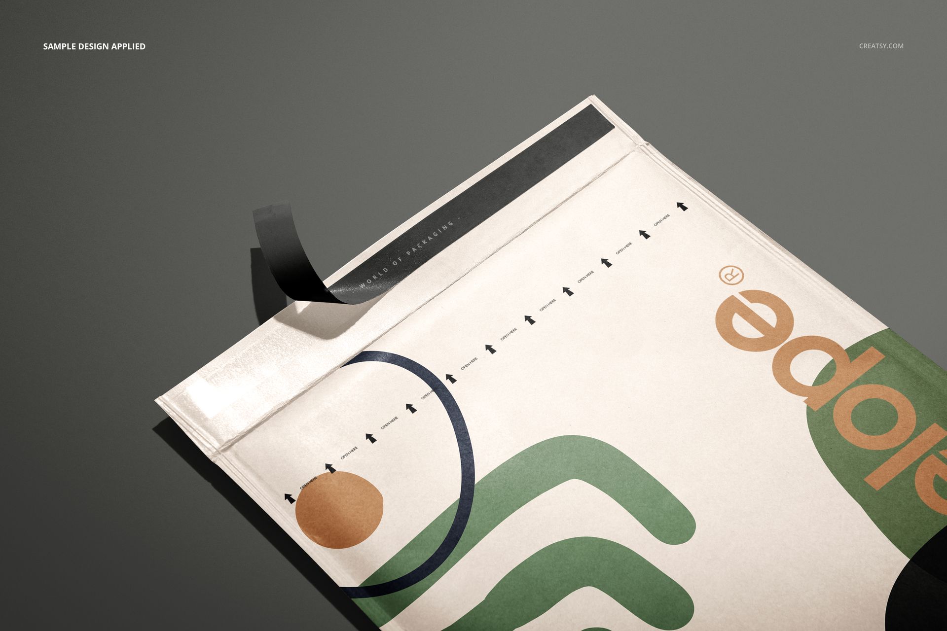 Close-up of kraft bubble mailer mockup featuring colorful geometric graphics and black tape on a gray surface.