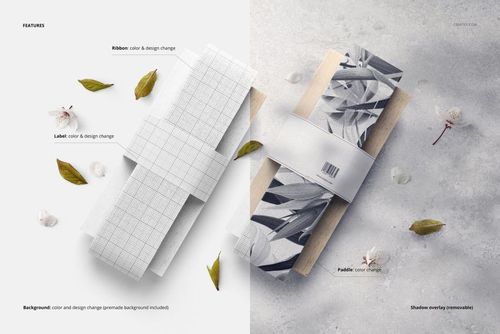 PSD mockup showing two cotton ribbons on paddles with different designs, surrounded by leaves and flower petals.