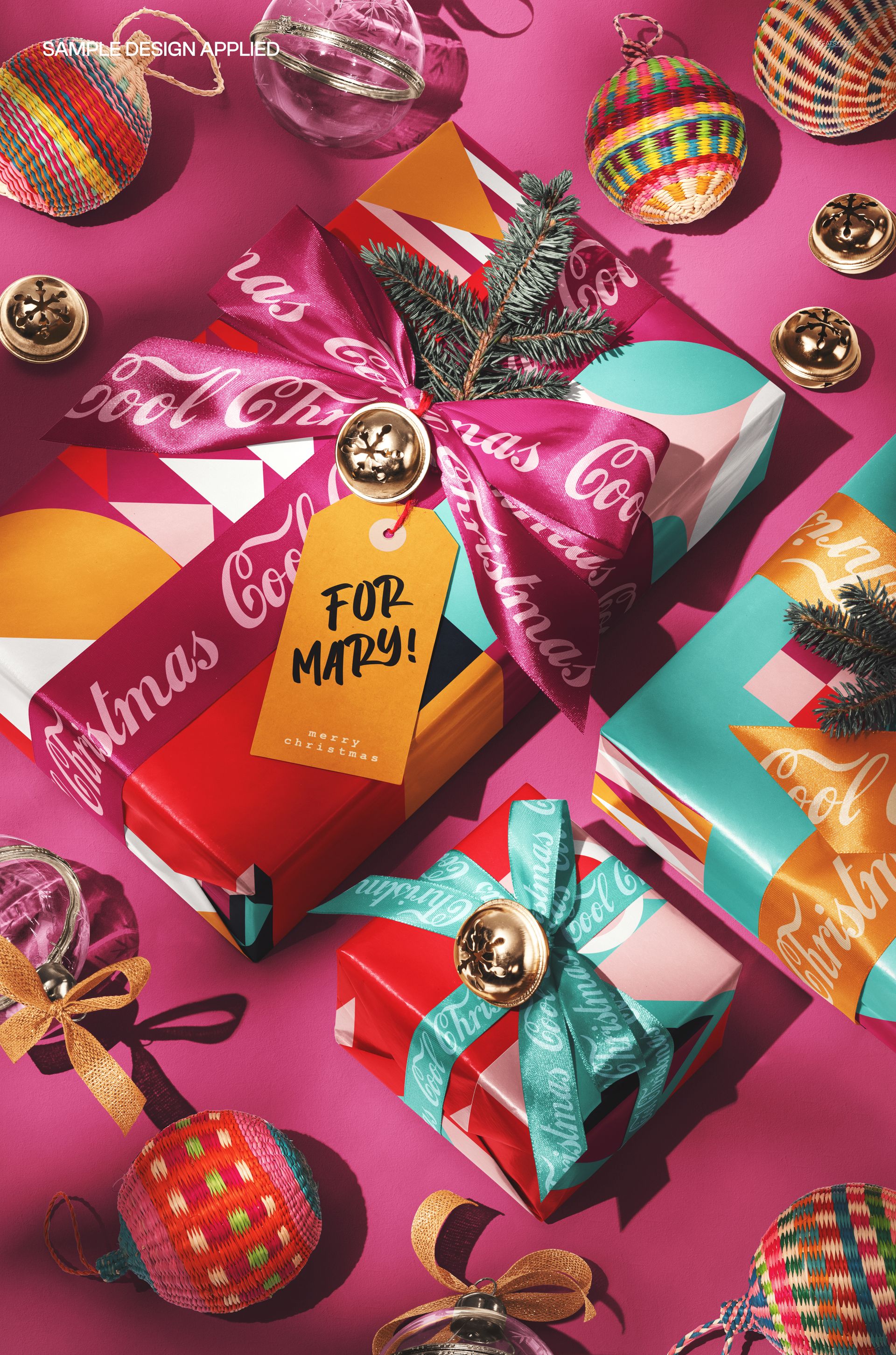 PSD mockup showing holiday presents decorated with vibrant paper, bows, gold bells, and Christmas ornaments.