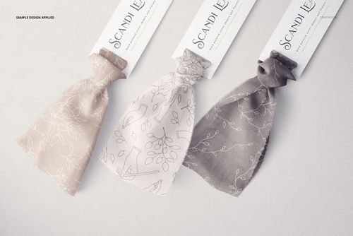 Three silk ribbons in beige and gray tones with floral line designs, shown with labels in a realistic mockup scene.