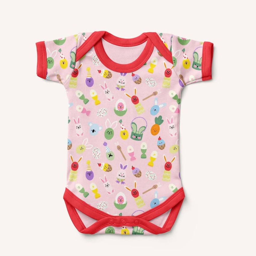Baby short sleeve bodysuit mockup featuring a pink fabric with colorful Easter-themed illustrations and red trim on a plain background.