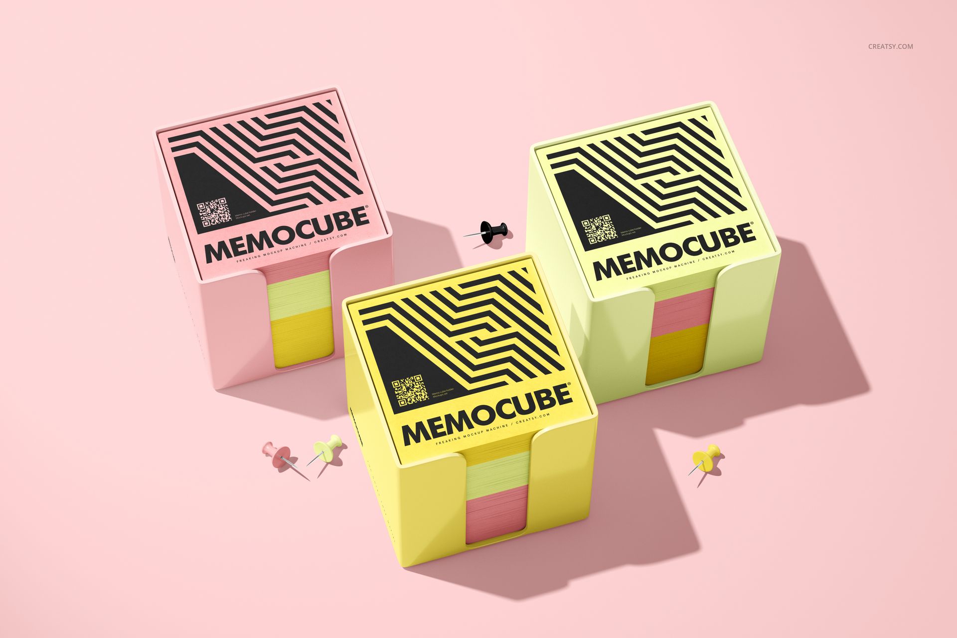 Front view of memo block cube mockups in acrylic holders, featuring pink and yellow colors and bold graphic designs.
