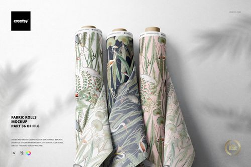 Fabric rolls mockup showing a trio of textile designs in soft green, blue, and pink shades with leafy motifs.