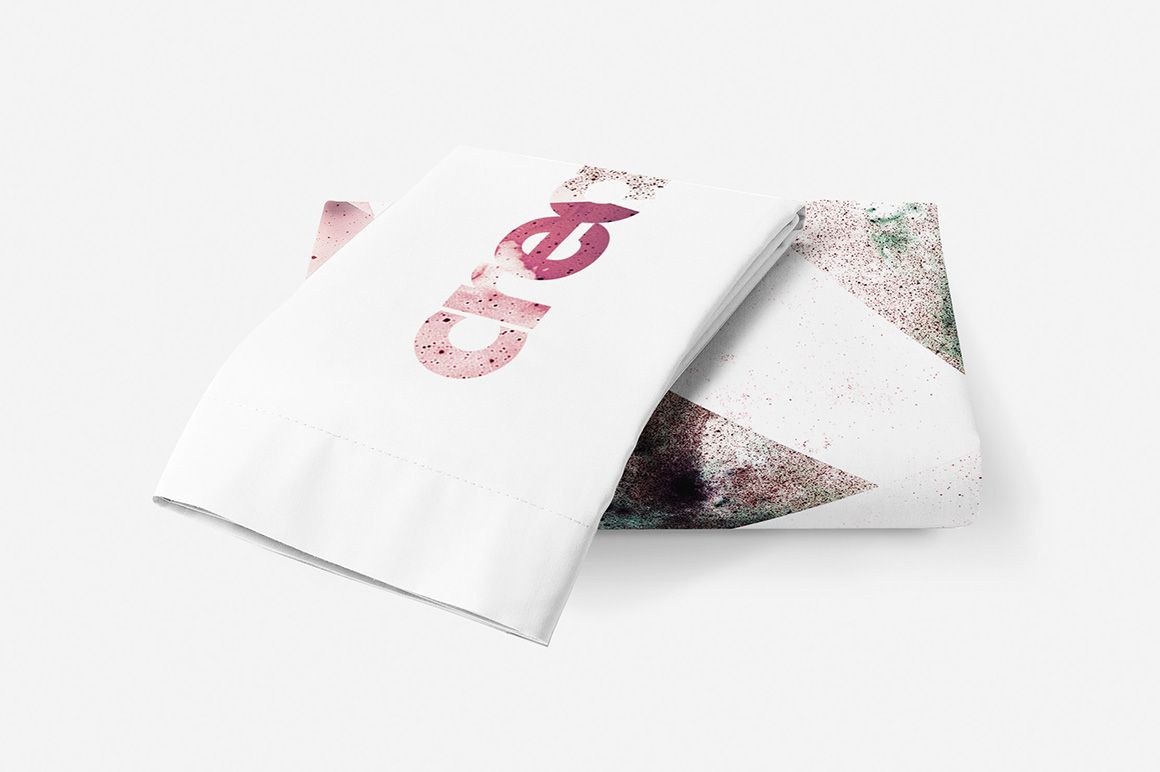 Single bed bedding mockup featuring a folded duvet with abstract pink and green patterns on a white background.