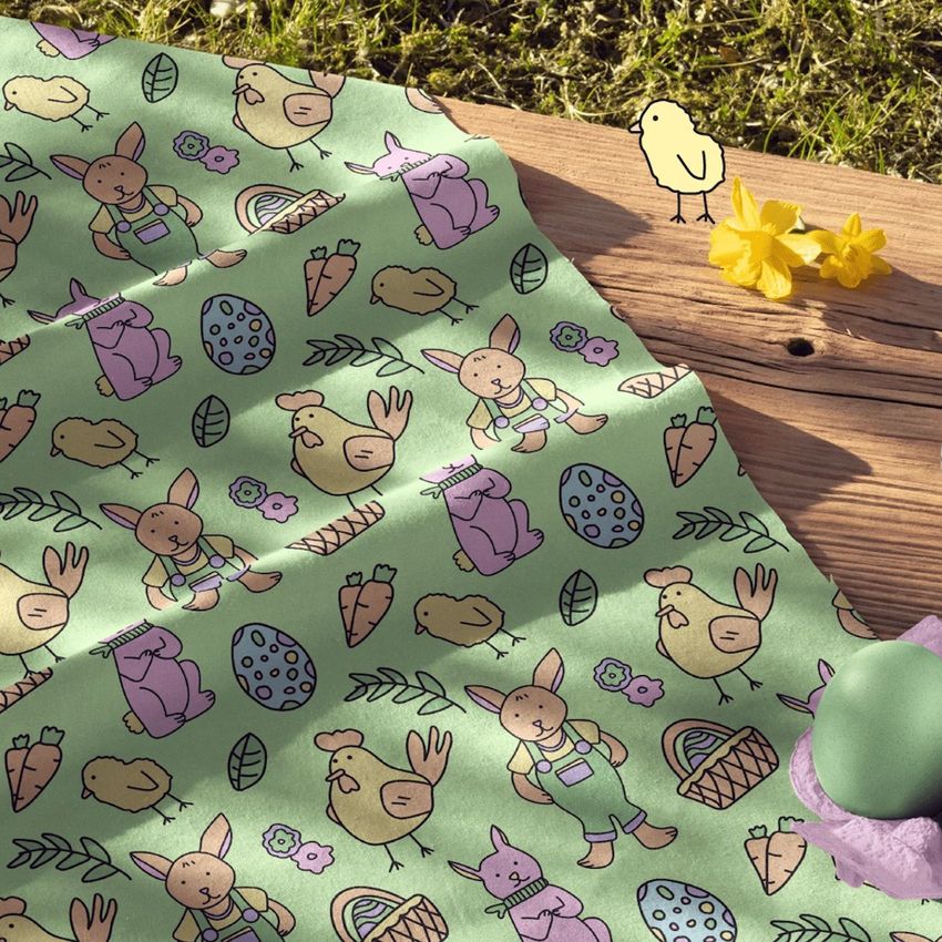 Cotton fabric mockup featuring a playful Easter pattern with bunnies, chicks, eggs, and baskets on a green background.