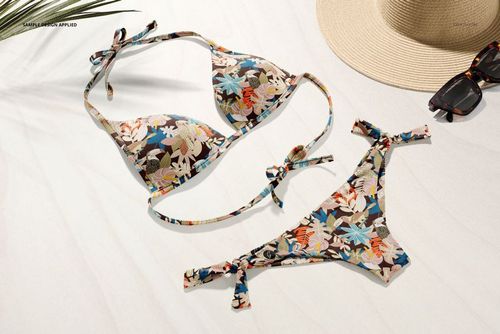 Bikini mockup set featuring a colorful floral design, shown from above with summer accessories on a white background.