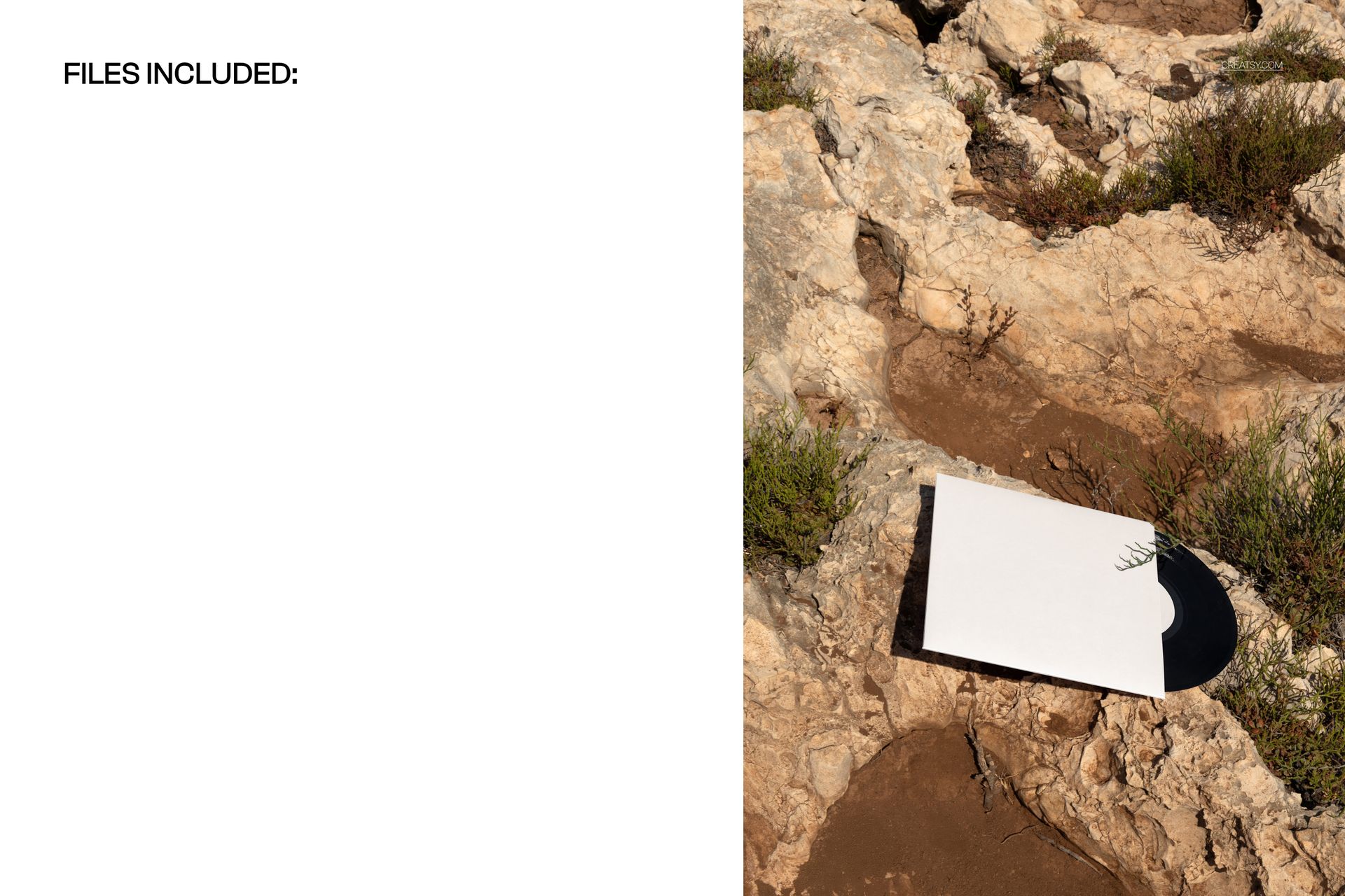 Top view of a black vinyl record mockup with a plain white cover placed on uneven rocky ground.