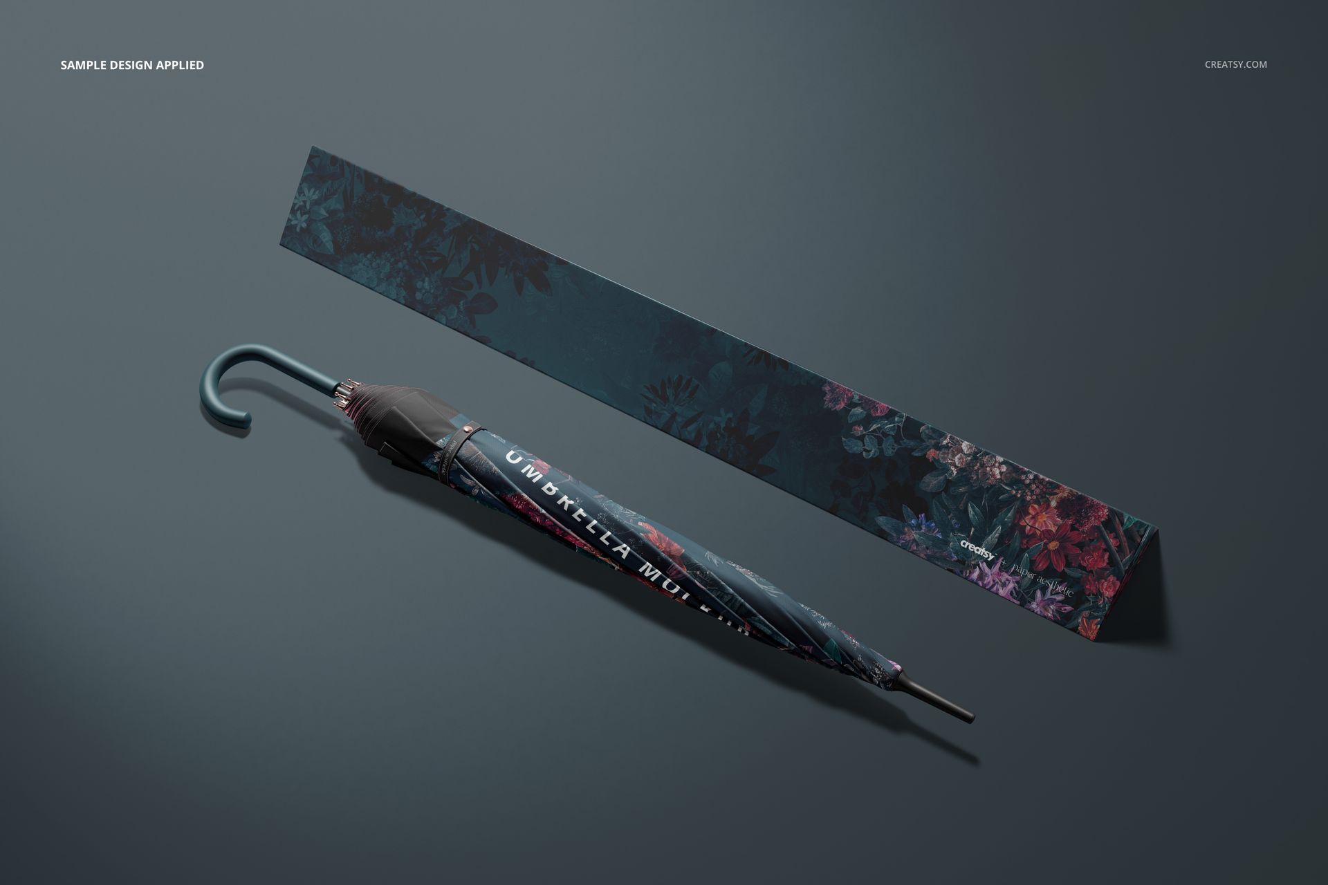 Umbrella and packaging mockup featuring a dark botanical design, shown from above on a neutral gray background.