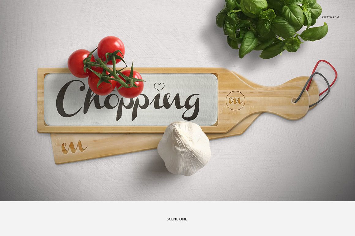 Wooden chopping board mockup with glass detail, tomatoes, garlic bulb, and basil leaves arranged on a white background.