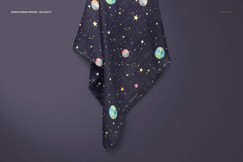 Muslin swaddle blanket mockup featuring a dark fabric with moon and star pattern, hanging against a plain wall.
