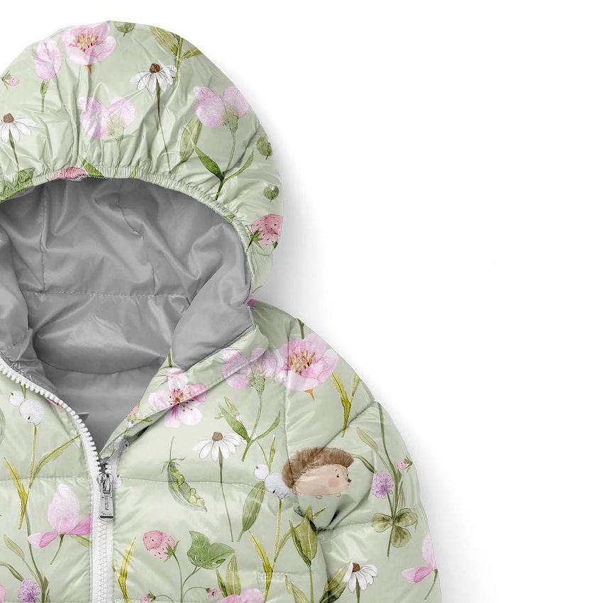 Kids winter jacket mockup with a light green background, featuring a floral and animal pattern in soft pastel colors.