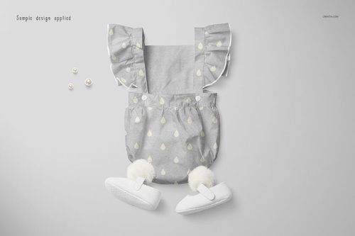 Front view of a baby romper mockup with ruffled shoulder straps, light gray fabric, and white teardrop pattern on a plain background.