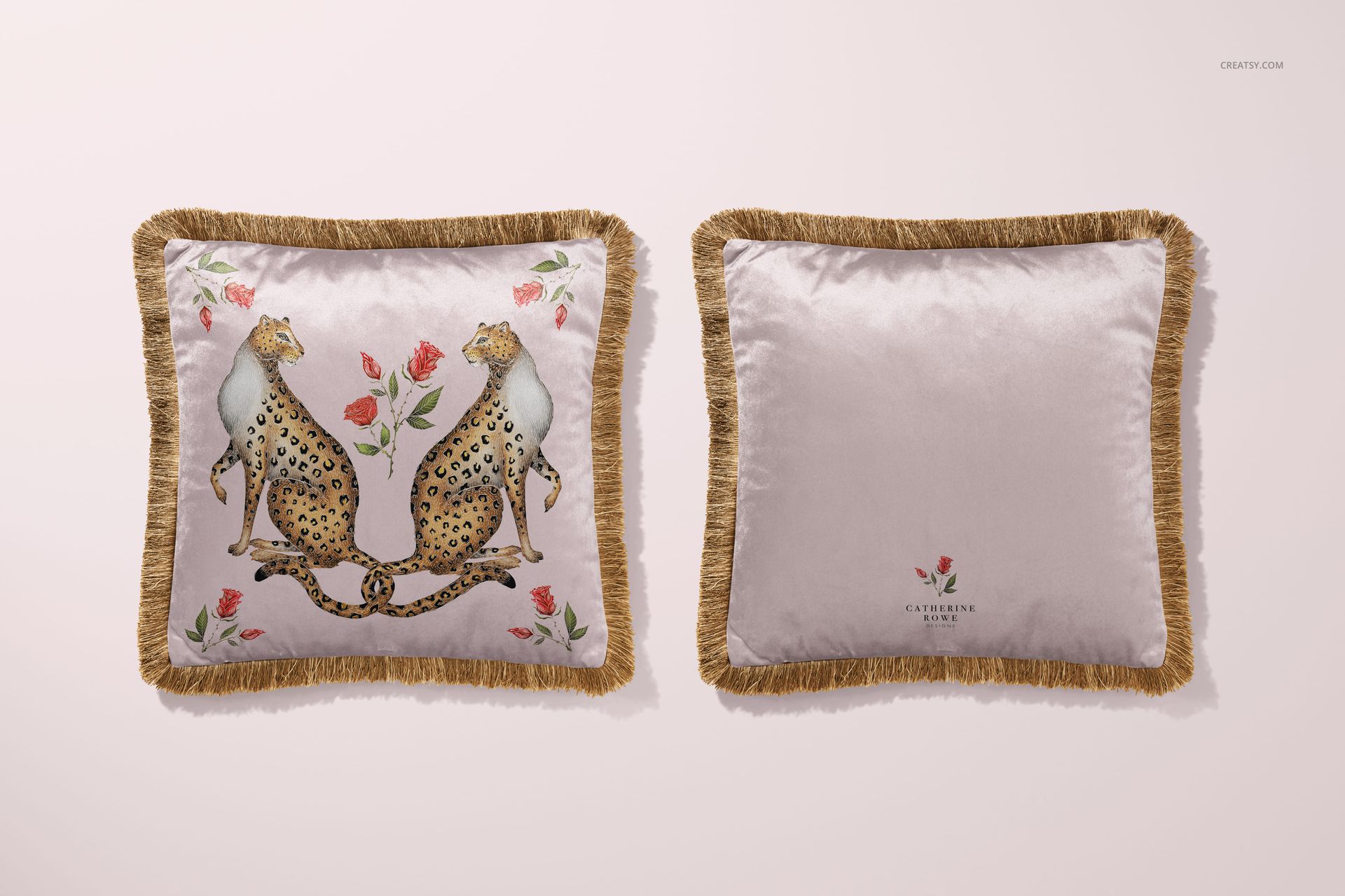 Square velvet pillow mockup with gold fringe, featuring two cheetahs and floral accents on a light background.