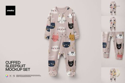 PSD mockup showing a cuffed baby sleepsuit with illustrated cat faces in various colors and beige backdrop.