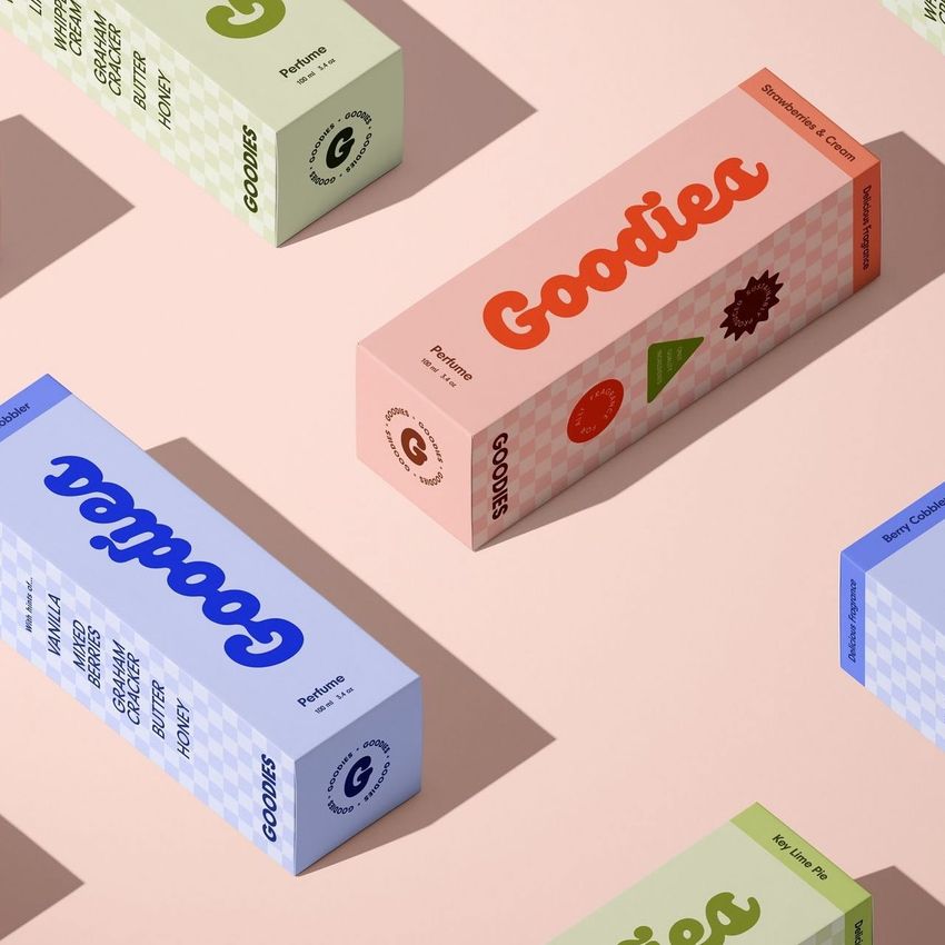 Tall box mockup featuring several rectangular packaging boxes in pastel colors arranged on a light pink surface with shadows.