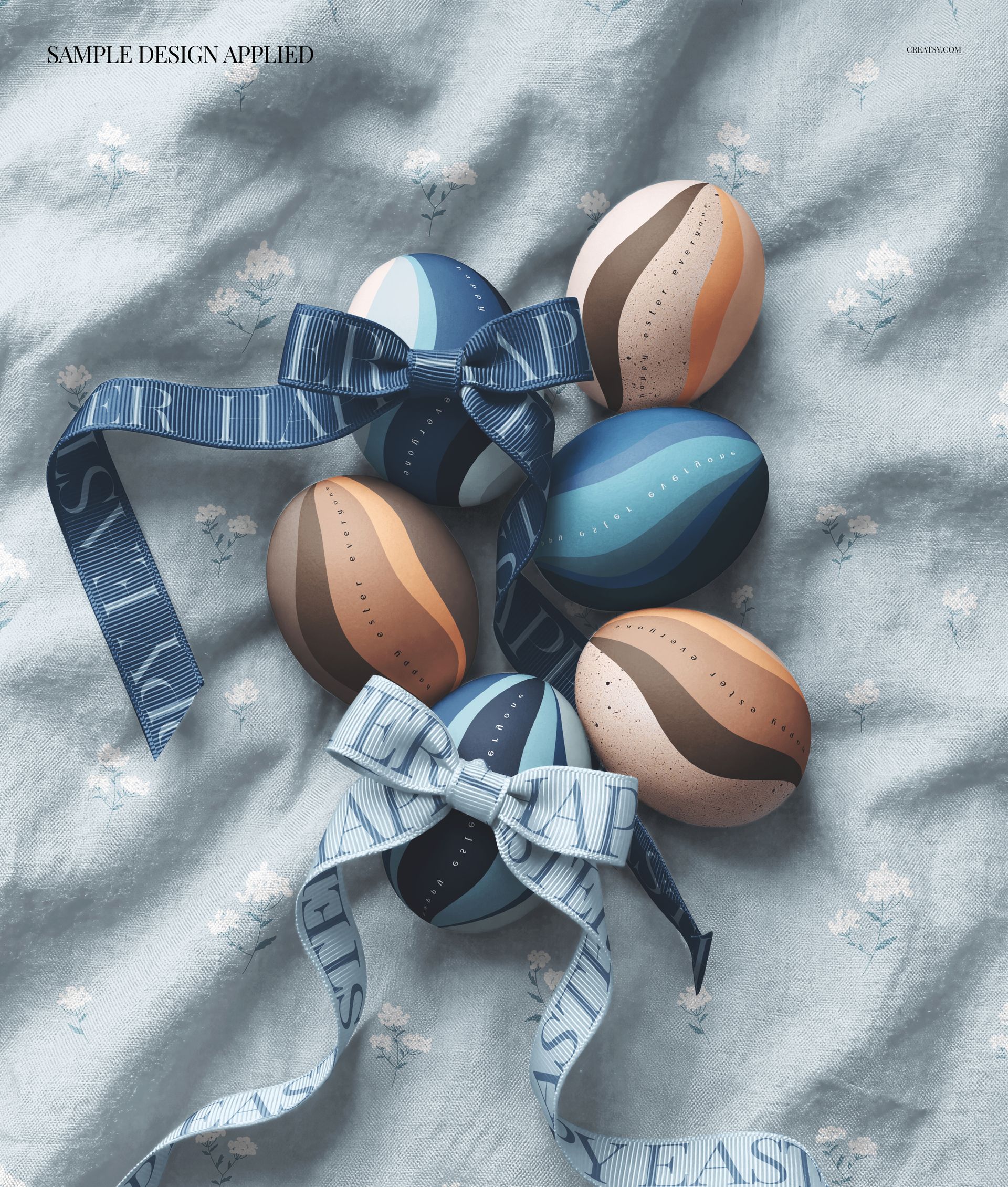 Front view of Easter eggs with blue and beige patterns and bows, arranged on light blue fabric in a PSD mockup.