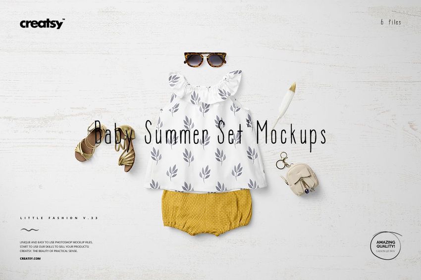 Flat lay of a baby summer set mockup with a white patterned top, yellow shorts, sandals, sunglasses, and baby accessories on a white wooden surface.