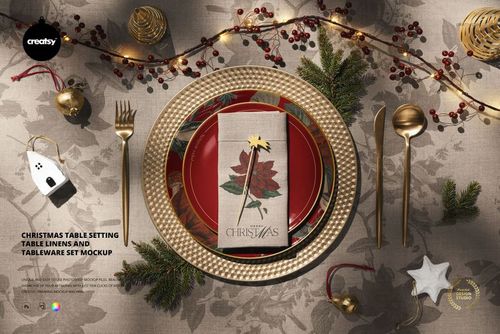 Top view of a Christmas-themed tableware set mockup featuring gold cutlery, plates, and a poinsettia napkin.
