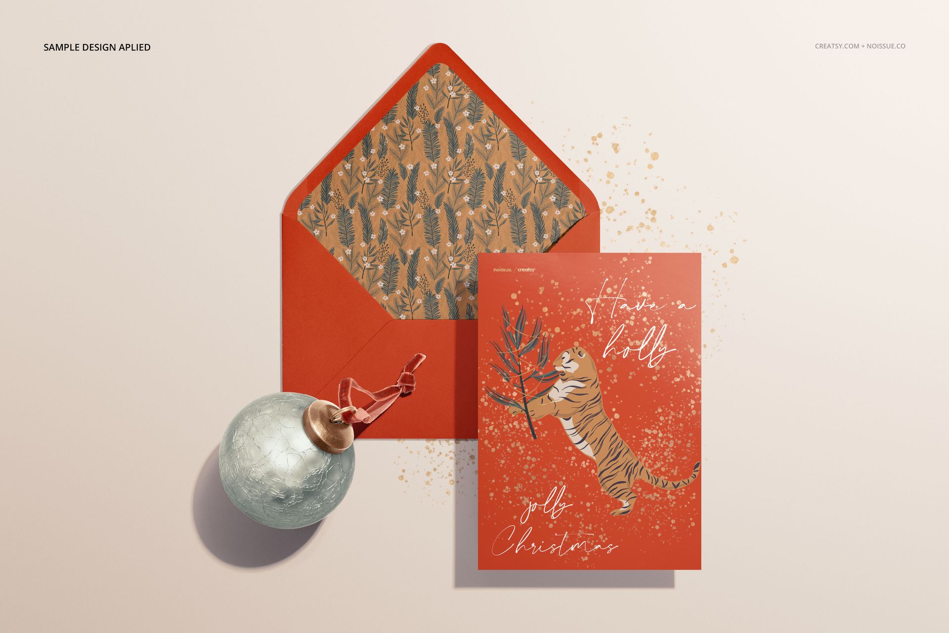 Stationery mockup featuring a red card with a tiger illustration and matching envelope with patterned lining, front view.