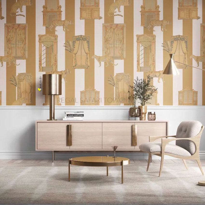 Modern mid-century interior wallpaper mockup featuring gold and beige safari-themed patterns behind a light wood sideboard and armchair.