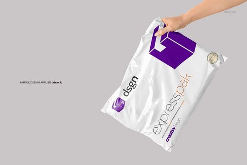 White packaging mailing bag mockup with bold purple graphics and orange accents, displayed at an angle in hand.